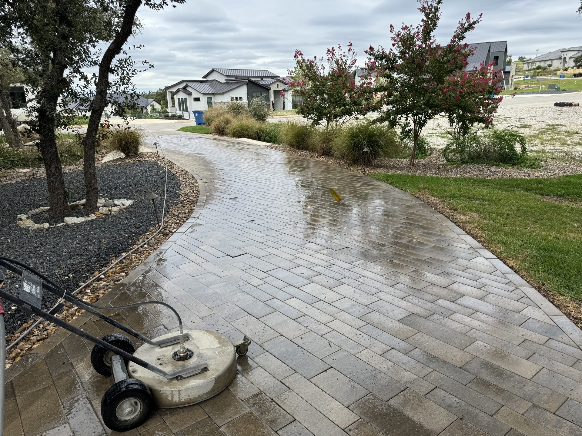 Surface cleaner working on a paver driveway in a Colorado suburb