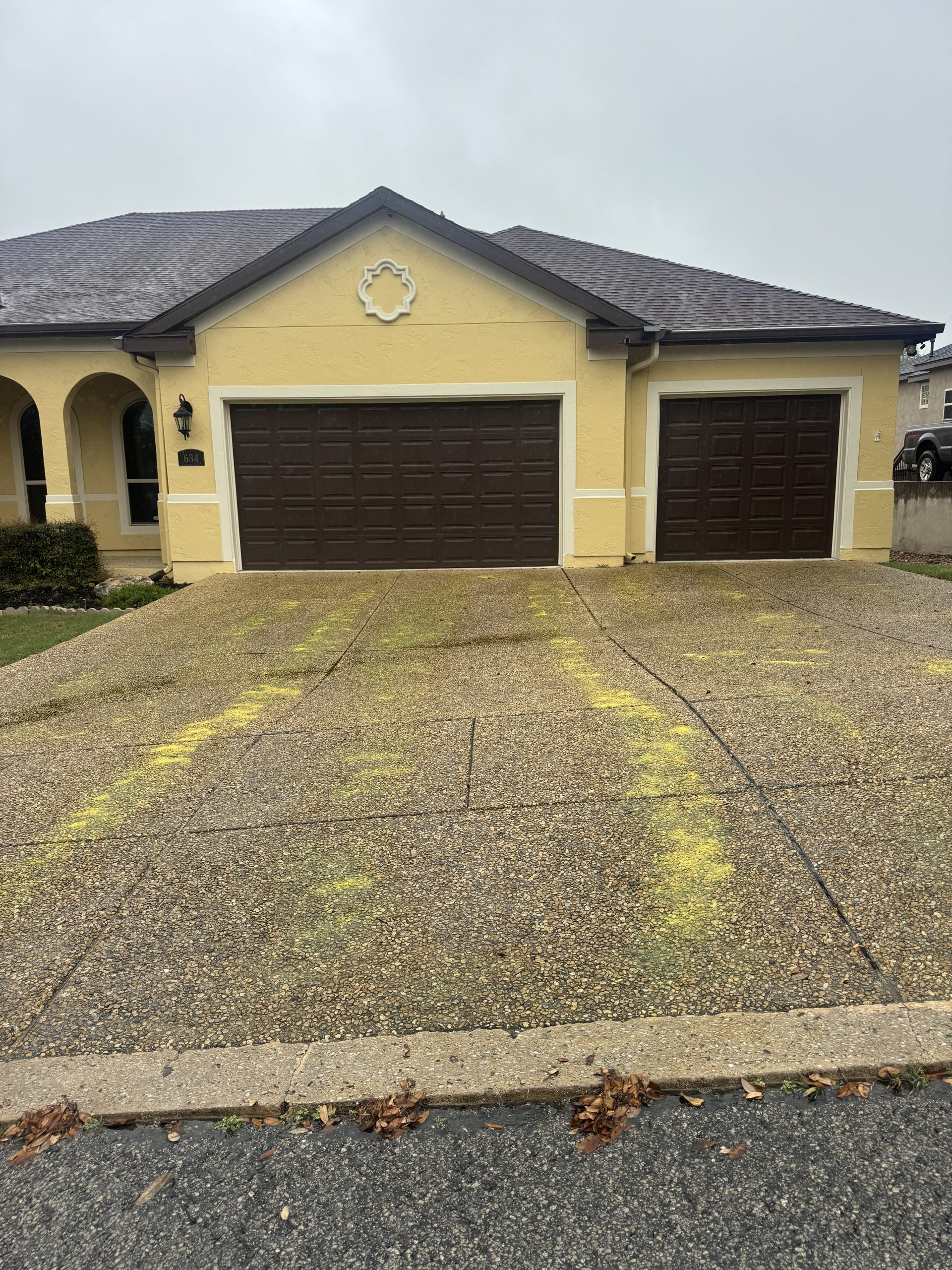 Concrete driveway before pressure washing — stained and dirty